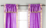 Cream sari rod pocket curtains hung at a window
