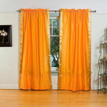 Pumpkin sari rod pocket curtains hung at a window