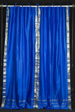 Blue sari tie top curtains hung at a window