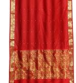 Red sari rod pocket curtains hung at a window