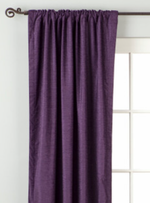 Purple velvet rod pocket curtains hung at a window