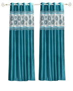 Turquoise sari grommet top curtains hung at a window