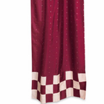 Maroon sari tab top curtains hung at a window