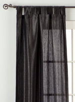 Black sari tab top curtains hung at a window