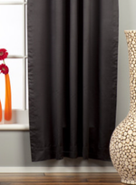 Black sari rod pocket curtains hung at a window