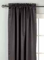 Black sari rod pocket curtains hung at a window