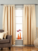 Golden sari tab top curtains hung at a window