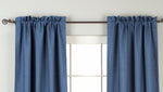 Blue raw silk rod pocket curtains hung at a window