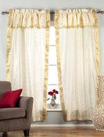 Cream sari rod pocket curtains hung at a window