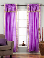 Cream sari rod pocket curtains hung at a window