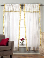 Cream sari rod pocket curtains hung at a window