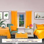 Pumpkin sari tab top curtains hung at a window