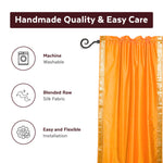 Pumpkin sari rod pocket curtains hung at a window
