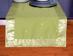 Olive green silk table runner running down a dining table