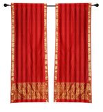 Red sari rod pocket curtains hung at a window