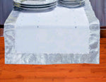 Silver silk table runner running down a dining table
