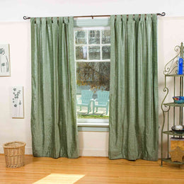 Olive green velvet tab top curtains hung at a window