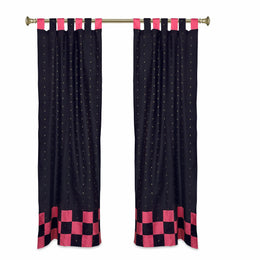 Black sari tab top curtains hung at a window