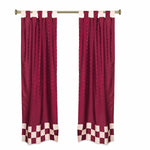 Maroon sari tab top curtains hung at a window