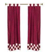 Maroon sari tab top curtains hung at a window