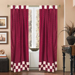 Maroon sari tab top curtains hung at a window