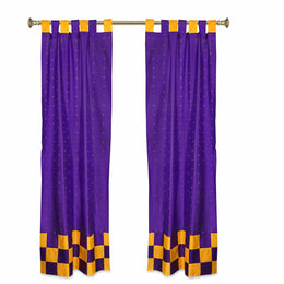 Purple sari tab top curtains hung at a window