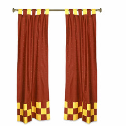 Yellow sari tab top curtains hung at a window