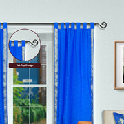 Blue sari tab top curtains hung at a window