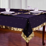 Black sari tablecloth laid on a dining table