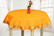 Orange sari tablecloth laid on a dining table