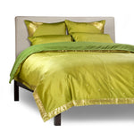 Olive green sari duvet cover set made up on a bed