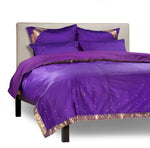 Purple sari duvet cover set made up on a bed