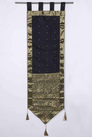 Black sari wall hanging displayed on a wall