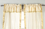Cream sari rod pocket curtains hung at a window