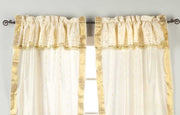 Cream sari rod pocket curtains hung at a window