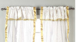 Cream sari rod pocket curtains hung at a window