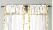Cream sari rod pocket curtains hung at a window