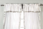 Cream sari rod pocket curtains hung at a window
