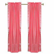 Silver sari rod pocket curtains hung at a window