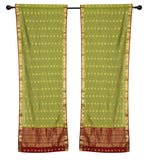 Green sari rod pocket curtains hung at a window