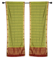 Green sari rod pocket curtains hung at a window