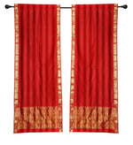 Red sari rod pocket curtains hung at a window