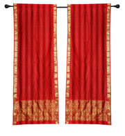 Red sari rod pocket curtains hung at a window