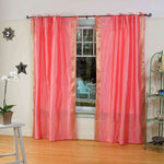 Pink sari tie top curtains hung at a window