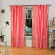Pink sari tie top curtains hung at a window