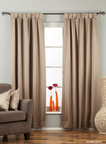 Gray sari tab top curtains hung at a window