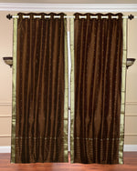 Brown sari grommet top curtains hung at a window