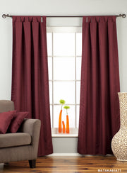 Maroon raw silk tab top curtains hung at a window