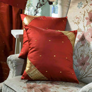 Rust sari cushion covers arranged on a sofa