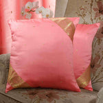 Peach sari cushion covers arranged on a sofa